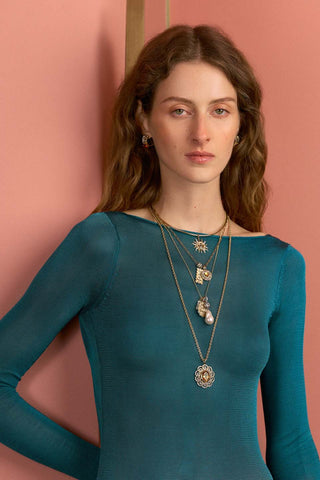 Model wearing necklace stack
