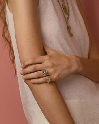 Close-up of a model wearing gold rings
