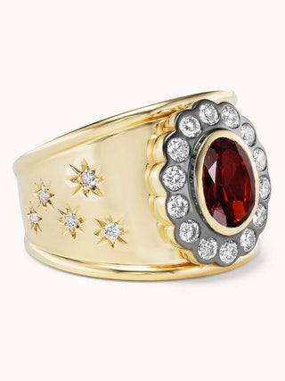 side view of gold cigar band ring with garnet and star designs