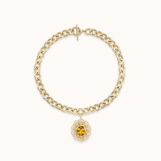 Gold chain necklace with a decorative pendant featuring a yellow citrine 