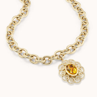 Gold chain necklace with a decorative pendant featuring a yellow citrine 