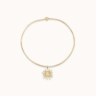 Gold necklace with a sun pendant 