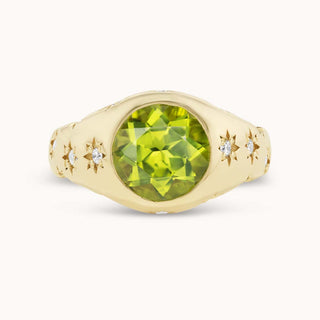 Gold ring with a peridot and smaller diamonds set in star bezels
