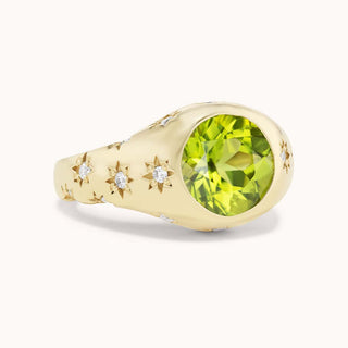 Gold ring with a peridot and smaller diamonds set in star bezels