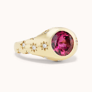 Gold ring with a pink tourmaline and smaller diamonds set in star bezels