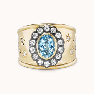 Gold cigar band ring with aquamarine and star designs
