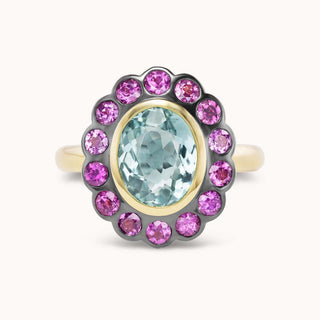 Ring with pink gemstones and a central blue gemstone