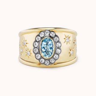 Gold cigar band ring with aquamarine and star designs