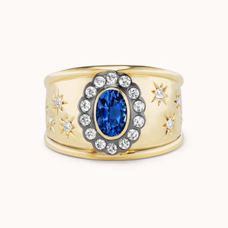 Gold cigar band ring with blue sapphire and star designs