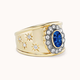 side view of gold cigar band ring with blue sapphire and star designs